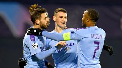 Phil Foden of Manchester City celebrates after scoring his team's fourth goal with Bernardo Silva and Raheem Sterling. Getty