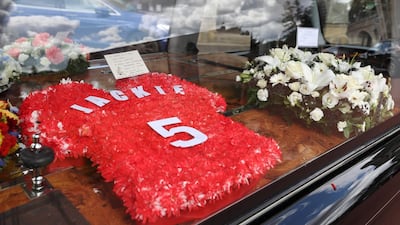Floral tributes and messages of condolence are pictured as the funeral cortege of British football legend Jack Charlton arrives at the West Road Crematorium. AFP