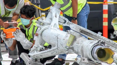 Lion Air investigators examine part of the landing gear of the ill-fated Lion Air flight JT 610 at the port in northern Jakarta. The Boeing 737 Max 8 with 189 people plunged into the Java Sea just 12 minutes after takeoff on a routine one-hour flight from Jakarta to Pangkal Pinang city in Sumatra on October 29. AFP