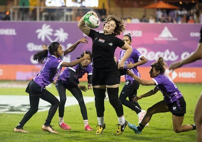 Al Arabi, in black, in action against all-Emiratoi women's team Al Maha at the Dubai Sevens. Ruel Pableo for The National