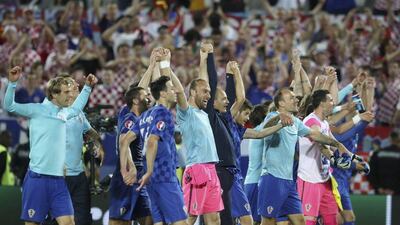 Croatia players celebrate and applaud their supporters after the 2-1 victory ove Spain that ensured top spot in Group D. David Josek / AP Photo