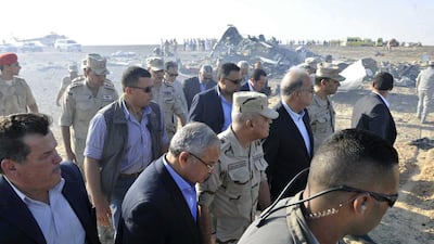 Egyptian Prime Minister Sherif Ismail, third right, along with military and government officials, tour the site where a passenger plane crashed in Hassana, Egypt, on Saturday. Suliman el-Oteify / Egyptian Prime Minister’s Office via AP