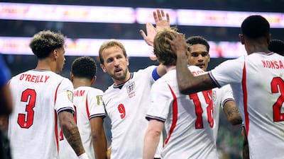 Harry Kane celebrates Jude Bellingham's second goal with teammates. Reuters