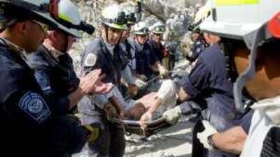 US rescuers carry Jens Christensen, a UN staff member, from the rubble of the UN headquarters on Sunday.
