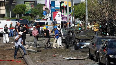 Lebanese workers clear rubble and glass from the site of a car bomb explosion in front of the entrance of a Lebanese Blom bank branch in Beirut. Nabil Mounzer / EPA