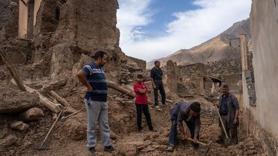 Men clear the rubble of houses that collapsed in Imgdal. Getty Images