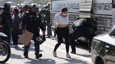 A protestor is put on a transport bus. EPA