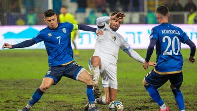 Israel defender Miguel Vitor, centre, fights for the ball with Kosovo midfielders Milot Rashica and Meriton Korenic. AFP