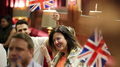 Britons celebrate the royal wedding of Prince Harry and Meghan Markle on board the QE2 in 2020. Pawan Singh / The National