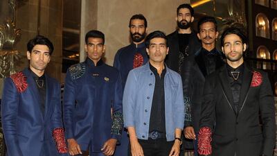 Indian Bollywood designer Manish Malhotra (C) and menswear models. AFP