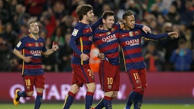 Barcelona striker Lionel Messi, centre, celebrates with teammates Neymar, right, and Sergi Roberto. Alejandro Garcia / EPA