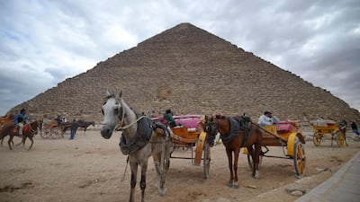 Tourist horse-drawn carts waiting by the base of the Great Pyramid at the Giza province, south of Egypt's capital Cairo. AFP