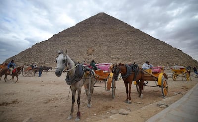 Tourist horse-drawn carts waiting by the base of the Great Pyramid at the Giza province, south of Egypt's capital Cairo. AFP