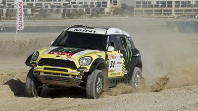 Nani Roma and co-driver Michel Perin plow their Mini All 4 through the sand during Super Stage 5 of the Abu Dhabi Desert Challenge on April 5, 2014. Courtesy Abu Dhabi Desert Challenge