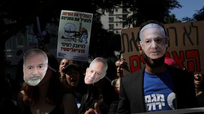 Protesters wear masks of Israeli Prime Minister Benjamin Netanyahu, Blue and White party leader Benny Gantz and Avigdor Leiberman of Yisrael Beiteinu. Ammar Awad / Reuters