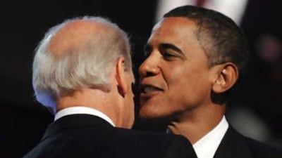 Democratic presidential nominee Senator Barack Obama, right, whispers into the ear of his running mate, Senator Joe Biden.