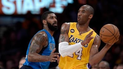 Kobe Bryant looks for a way past Dallas' OJ Mayo.