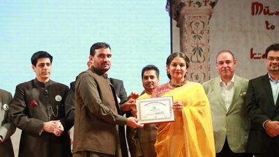 Muhammad Ahmed Shah, left, was awarded for his dedication and services to the Urdu language in Pakistan