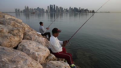 People fish in the early morning with the skyline in the background, in Doha, Qatar. Saudi Arabia, Egypt, the United Arab Emirates and Bahrain severed diplomatic ties and cut air, ground and sea links to Qatar over its support of terrorist groups and its warm relations with Iran. (AP Photo/Kamran Jebreili)