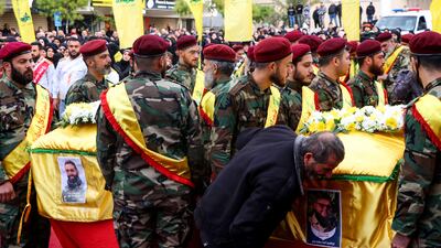 Hezbollah fighters carry the coffins of a fellow fighter and of one of his relatives who were killed in Israeli bombardment, in Bint Jbeil, in the south of Lebanon, on December 27. AFP