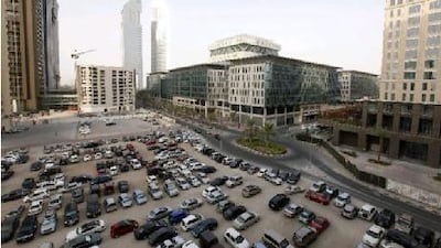 An unmarked parking area crammed with cars opposite the DIFC building. Jeffrey E Biteng / The National