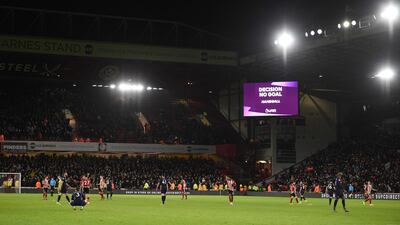 The big screen shows the VAR decision ruling out a goal by West Ham United's Scottish midfielder Robert Snodgrass because of a handball in the build up. AFP