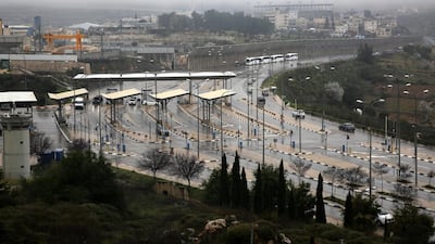 Tourist busses wait at an Israeli checkpoint as preventive measures taken against the coronavirus in Beit Jala, near Bethlehem. EPA