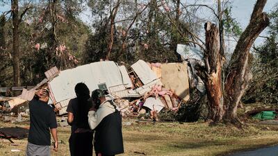 People look at a mobile home destroyed by the tornado in Mount Vernon. EPA