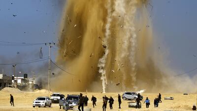 Palestinians run for cover as smoke rises following an Israeli air strike on a Hamas post, in the northern Gaza Strip. Mohammed Abed / AFP Photo / February 6, 2017