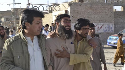 Family members visit a police training centre where gunmen opened fire in Quetta, Pakistan. Dozens of cadets were killed in the attack. Arshad Butt / AP Photo