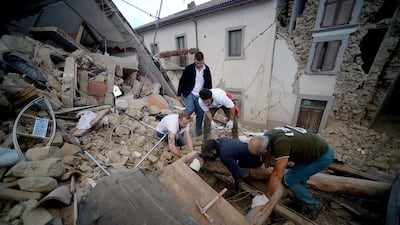 Residents search for victims in the rubble caused by an earthquake in the central Italian village of Amatrice on August 24, 2016. Amatrice was one of three villages where people were killed when a quake struck a mountainous area straddling the regions of Lazio and Marche. Filippo Monteforte / AFP