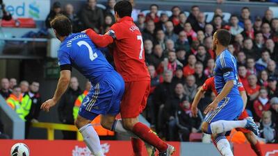 Luis Suarez clashes with Chelsea's Branislav Ivanovic in the build-up to the biting incident at Anfield. Pic: Andrew Yates/AFP