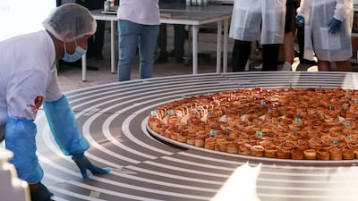 A warm, sweet scent filled the air inside the Swedish pavilion at the world’s fair, as an attempt to create the world’s 'longest cinnamon bun train' got under way.