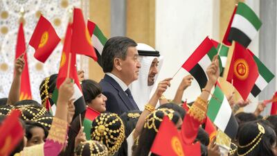 Sheikh Mohamed and President Jeenbekov stand for a photograph with schoolchildren. Rashed Al Mansoori / Ministry of Presidential Affairs