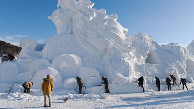 Workers carving a dragon sculpture from snow and ice in preparation for the winter tourism season in Mohe in China's northeast Heilongjiang province. AFP