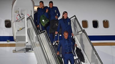 Left to right: Brazil's Firmino, Danilo, Filipe Luis and Miranda descend from the plane upon the team's arrival at Sochi airport in Russia on Monay ahead of the World Cup. Nelson Almeida / AFP