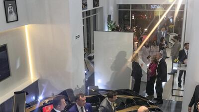 Attendees stand beside a Lotus in the brand's trademark colours.