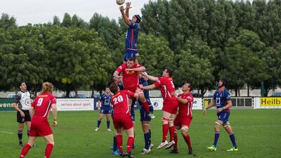 Bahrain, in red, scored a late try to snatch victory against Jebel Ali Dragons on Friday. Victor Besa for The National