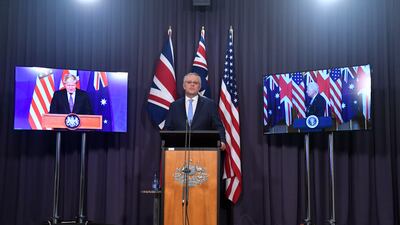 UK Prime Minister Boris Johnson, Australia's Prime Minister Scott Morrison, centre, and US President Joe Biden attend a joint press conference as they agree to the creation of a trilateral security partnership, known as Aukus.