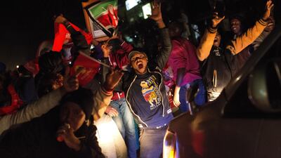Supporters of President Uhuru Kenyatta celebrate in Kikuyu Town after he was declared the winner of the presidential election