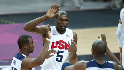 Kevin Durant (5), Chris Paul (13) and Kobe Bryant (10) react during the first half of a preliminary men's basketball game against France at the 2012 Summer Olympics in London. Durant, the Oklahoma City Thunder star who topped the NBA this season in scoring, is returning to Team USA for the Basketball World Cup. Jae C Hong / (AP Photo