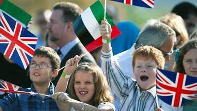 Hundreds of children await the arrival of Queen Elizabeth II at Emirates Palace to unveil a commemorative plaque to celebrate the commencement of construction of the Zayed National Museum yesterday.