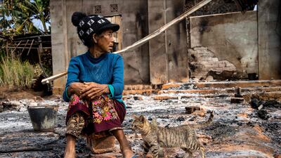 A woman outside her damaged house after fighting between the military and the Kachin Independence Army in Nam Hpat Kar, Myanmar. AFP