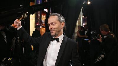 Emmanuel Lubezki appears backstage with the award for best cinematography for The Revenant. AP