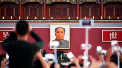 People take pictures on September 9, 2016, at the flag raising ceremony on Tiananmen Square in Beijing, China, on the 40th anniversary of the death of Mao Zedong. Thomas Peter / Reuters
