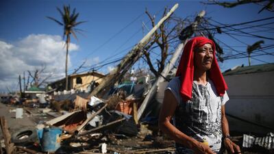 A man walks by a demolished street in Leyte, Philippines. Countries all over the world have pledged relief aid to help support those affected by the typhoon but damage to the airport and roads have made moving the aid into the worst-affected areas very difficult. Dan Kitwood / Getty Images