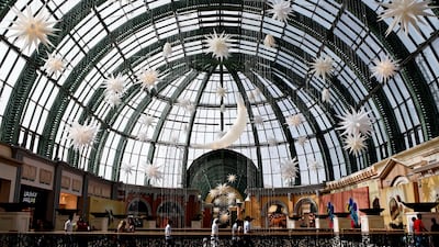 Shoppers walk by Ramadan decorations hanging in Mall of the Emirates in Dubai, July 29, 2013. Sarah Dea / The National