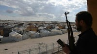 A member of the Syrian government forces looks towards the empty Al Hol camp. AFP