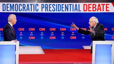 Former Vice President Joe Biden listens as Senator Bernie Sanders speaks during the 11th Democratic candidates debate of the 2020 US presidential campaign, held at CNN's Washington studios. Reuters