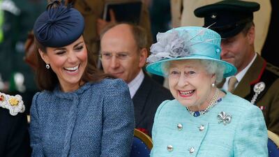 The Duchess of Cambridge and Queen Elizabeth watch a children's sporting event in 2012. Getty